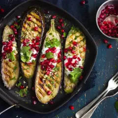 Grillade auberginehalvor toppade med yoghurt, granatäppelkärnor och nötter. Ett läckert fodmap recept som är både vackert och gott.